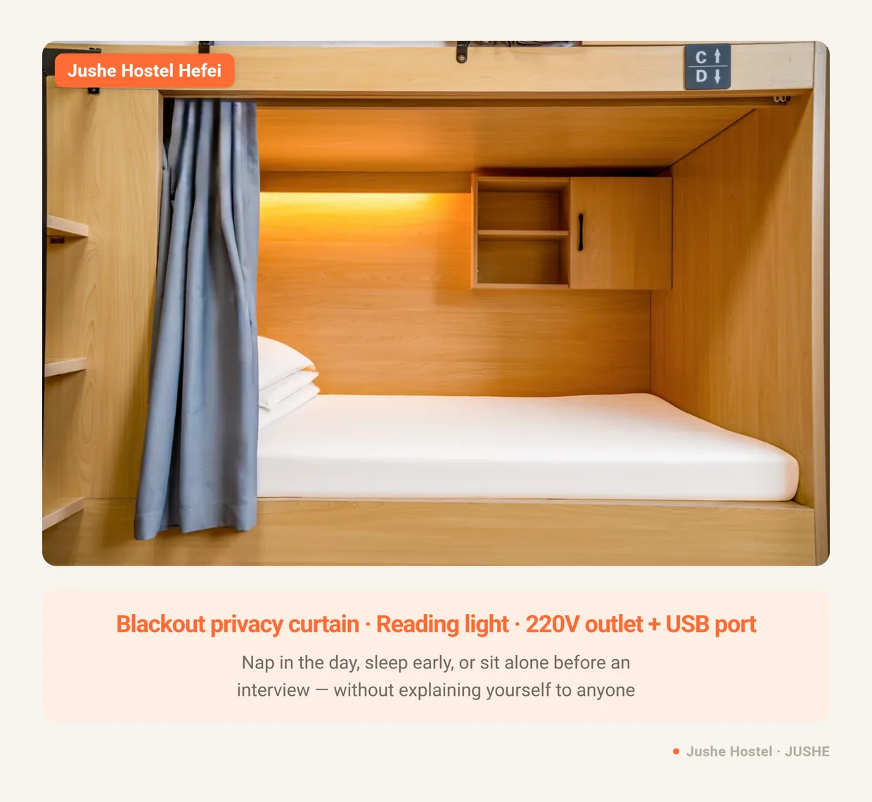 A Jushe Hostel berth with its blackout privacy curtain, reading light, outlet and USB port